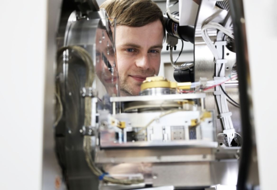 Max Birch beside laboratory equipment